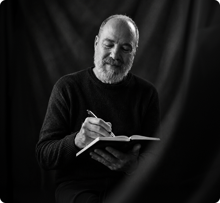 Rick Goldman writing in a notebook